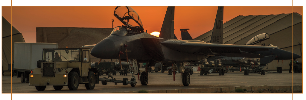 F-15E Strike Eagle on tarmac against orange sunset